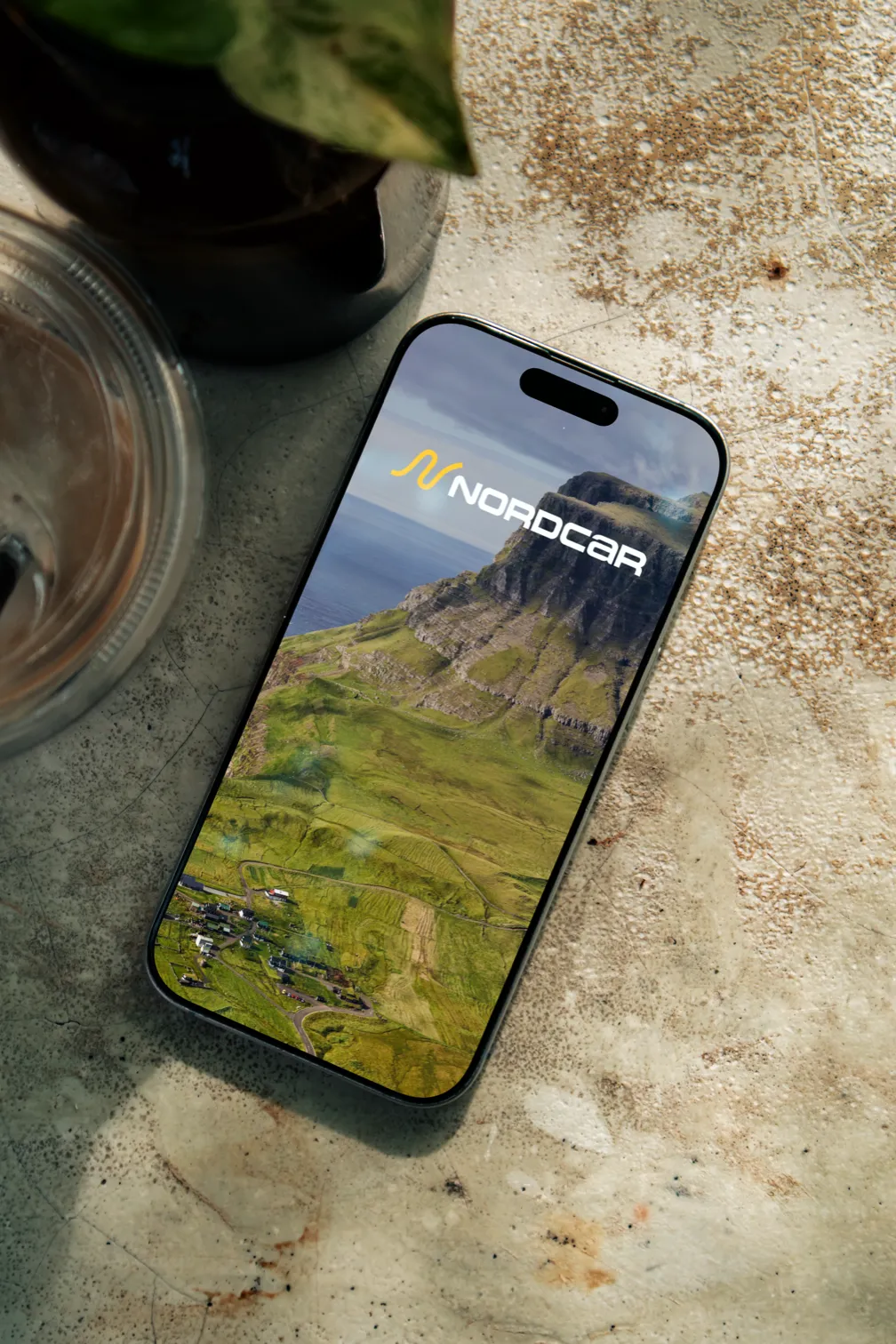 Nordcar app on iPhone showing Faroe Islands landscape